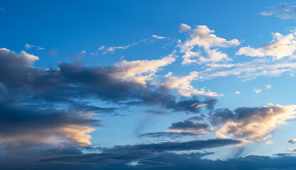 Sky background. Blue evening sunset sky with clouds.