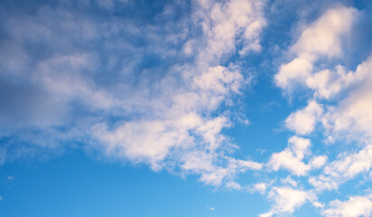 Sky background. Blue evening sunset sky with clouds.