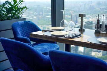 The interior of restaurant on top floors of skyscraper. View overlooking town.
