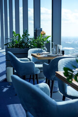 The interior of restaurant on top floors of skyscraper. View overlooking town.