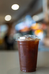 Iced americano coffee in package for takeaway. Cold beverage product.