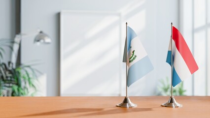 FLAGS OF GUATEMALA AND LUXEMBOURG ON TABLE