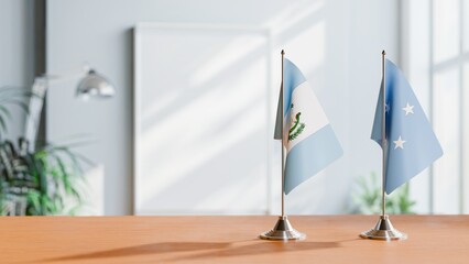 Obraz premium FLAGS OF GUATEMALA AND MICRONESIA ON TABLE