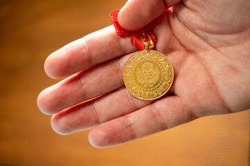 gold turkish coin in hands