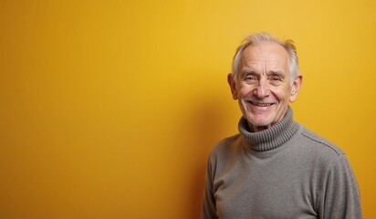Obraz premium Cheerful Senior Man Smiling Warmly Against Bright Yellow Background with Copy Space