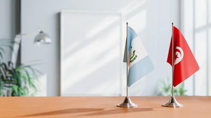 Obraz premium FLAGS OF GUATEMALA AND TUNISIA ON TABLE