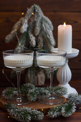 New Year's milk drink in glass glasses, Fir branches, New Year holiday