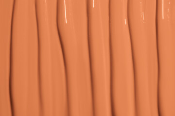 Texture of foundation cream covering the entire image. Makeup background, smooth and even tones.
