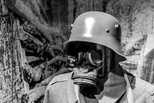 Close-up of a world war one soldier wearing a gas mask and helmet in black and white, historical military equipment, wartime trench scene, scary eerie atmosphere, protection from chemical warfare