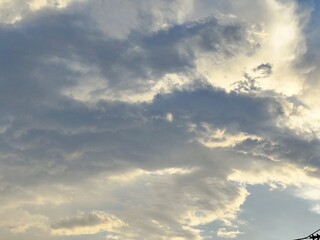A beautiful sky filled with white clouds and bright sunlight, creating a dramatic landscape that captures the essence of a summer day