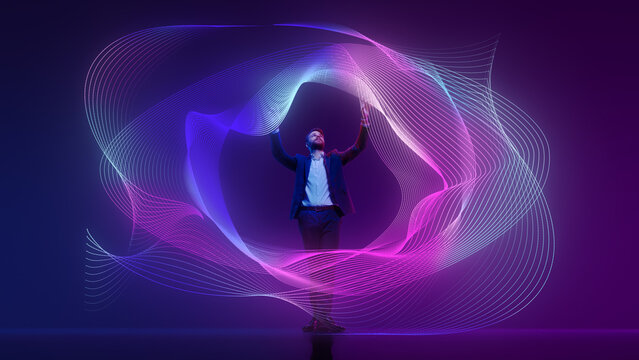 Young man, leader, stands, immersed in stream of colorful digital data against colorful gradient background. Advanced analytics Concept of information, connection, network, business, modern technology