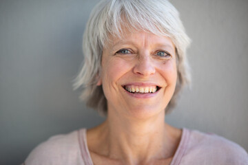 Smiling older woman with grey hair in a casual portrait