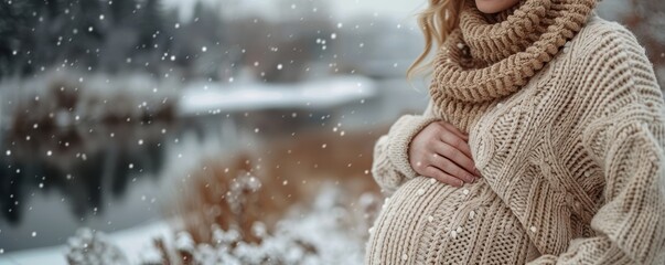 Pregnant woman in knitted sweater against winter landscape. Banner, copyspace