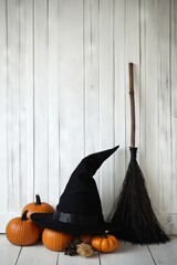 Black Witch Hat, Broom, and Pumpkins Against White Paneled Wall - AI generated illustration