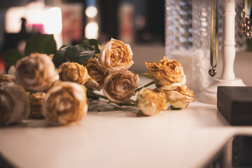 wilted roses on the dresser