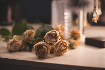 wilted roses on the dresser