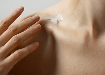 Applying moisturizer to nourish the skin.