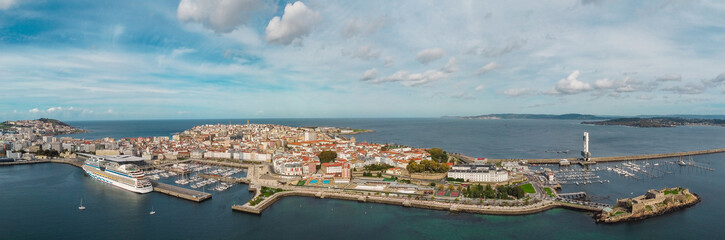 Panoramic aerial view of A Coru&ntilde;a City. View of Harbour and Old town center. Famous travel destination in Galicia, North-west of Spain. Large cruise ship doked in the port. Cloudy day. 