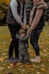 Family in nature in an autumn park with a child