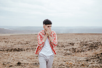 Young Man Standing in Field