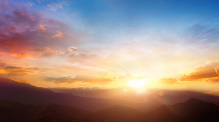Panorama of beautiful sunset over the mountain range with clouds in the sky
