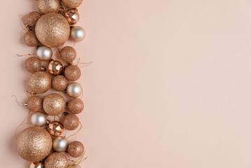 Beige Christmas background with golden stars and glitter ornaments. Christmas and Happy New Year celebration concept. Top view