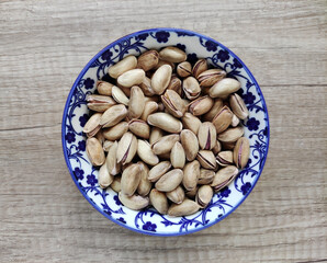 Fresh natural dried pistachios in a decorative plate 