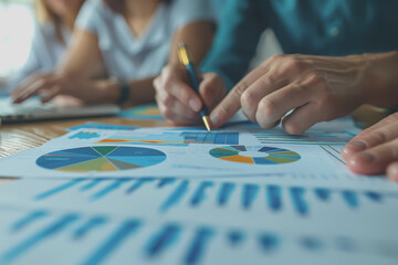 Obraz premium Hands business team having a meeting to analyze data graph charts for a marketing plan in the office