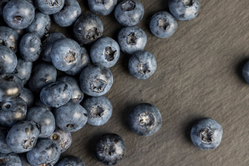 a pile of blueberries scattered on the board