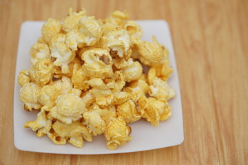 Homemade popcorn, made from seeds of maize or corn by baking or heating, mixed with salt, sugar and butter caramel. Concept, delicious snack. Agriculture product as food.