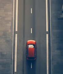 aerial view of modern red car driving on straight asphalt city road with copy space
