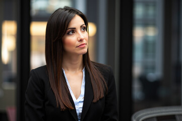 Businesswoman looking up and thinking in office building