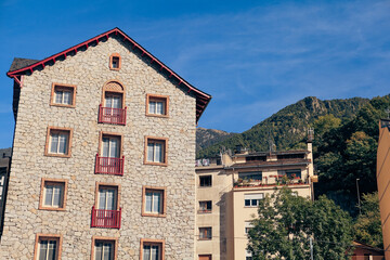 Historic stone buildings in Andorra under a clear blue sky during the day