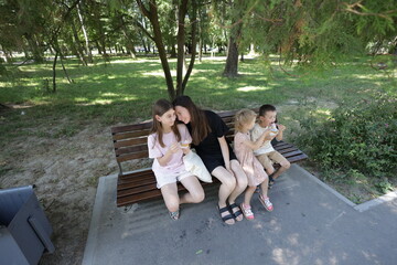 Mother and three children having fun in the park