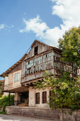 Abandoned brick building with broken windows and weathered facade