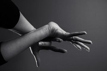 Two human hands making delicate and expressive gestures against a plain background. Abstract hands gestures. Palms with spread fingers. Communication, expression, feelings, art concepts	