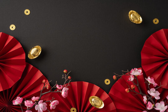 Elegant Chinese New Year themed background with red paper fans, gold coins, and blooming peach blossoms on a dark backdrop