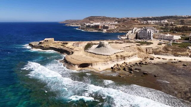Aerial footage of Xwejni Rock and Qolla l-Bajda Battery, Gozo Island, Malta
