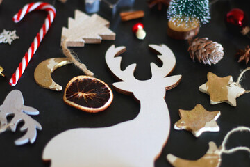 Various Christmas decorations in neutral colors on dark background. Selective focus.