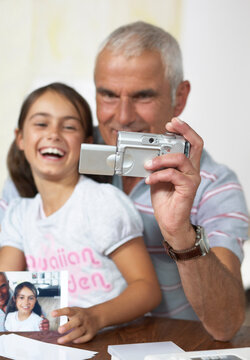 Grandfather and Granddaughter With Digital Camera