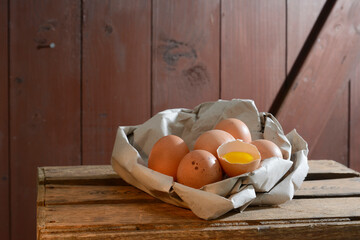 Organic brown eggs in paper on wooden table