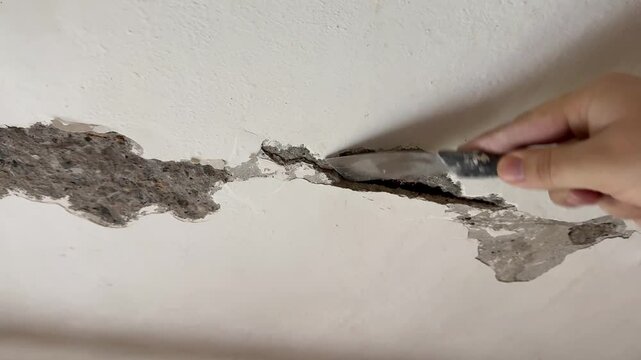 Male hand with spatula,repair concept.
