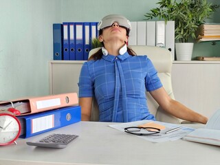 Woman relaxing with eye and neck massager at work place in office