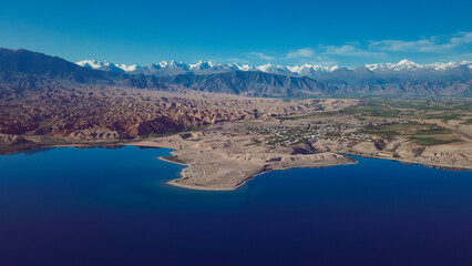Aerial view of stunning Kyrgyzstan landscape featuring mountains and serene water