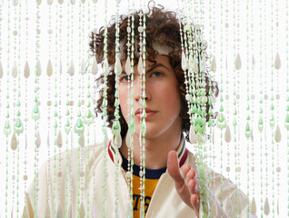 Portrait of Man Behind Beaded Curtain