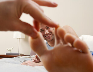 Man's Face framed by Hand and Foot