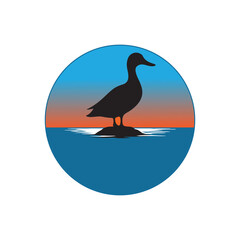 Silhouette of a duck standing on a rock in the middle of blue water