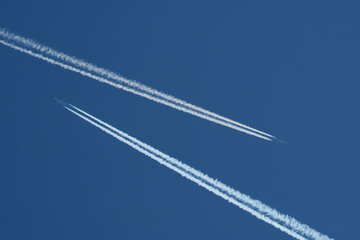 Airplane trails in the blue sky, contrails.