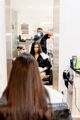 The model and photographer before starting the dye work in the hair salon,
both looking in the mirror