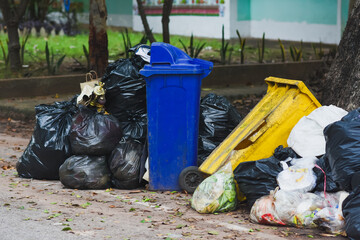 Plastic bins filled with trash and debris in public places